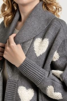 This Ribbed Heart Cardigan, crafted with meticulous attention to detail, boasts ribbed cuffs, a ribbed hem, and a ribbed placket, adding a hint of sophistication to its design. The true highlight of this cardigan lies in its delightful textured hearts, which adorn the fabric with grace and elegance, adding a whimsical touch. The cardigan features a folded collar to complement its charming features, exuding an air of refined elegance; plus, the lightweight yet warm fabric makes it an ideal compan Fitted Heart Print Sweater For Fall, Fall Long Sleeve Heart Print Outerwear, Trendy Winter Outerwear With Heart Print, Fall Heart-shaped Sweater, Trendy Heart Print Cardigan For Fall, Cozy Heart-shaped Sweater, Chic Winter Jacquard Knit Cardigan, Heart-shaped Knitted Sweater For Fall, Cozy Fall Sweater With Heart Shape