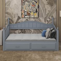 a blue daybed with drawers underneath it in front of a painting on the wall