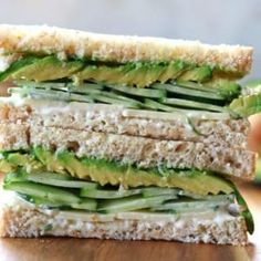 a close up of a sandwich with avocado and cheese on it sitting on a table