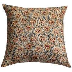 a decorative pillow with an intricate design on the front and back, in red, blue,