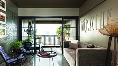 a living room filled with furniture and pictures on the wall next to a door that leads to a balcony