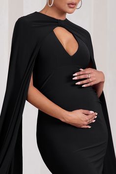 Opt for opulence at your next black tie event in Standing Ovation. This enchanting black maternity maxi dress was designed in our signature stretch jersey that hugs each curve and effortlessly accentuates your frame. Defined by extravagant cape sleeves. keep Standing Ovation at the forefront by styling it with a tousled bun and strappy stilettos. Features - Premium stretch jersey - Plunge neckline- Cape sleeves- Knot detail- Open back- Invisible zip closure - Fishtail skirt- Maxi length Sizing & Black Maternity Maxi Dress, Club L London, Standing Ovation, Maternity Maxi Dress, Wedding Shoes Bride, Black Dress Prom, Fishtail Skirt, Strappy Stilettos, Black Tie Gala