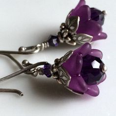 "Adorable and sweettiny amethyst tulips from my \"Bouquet of Flowers\" collection These precious little tulips are designed from dark amethyst colored Swarovski crystals capped with beautiful acrylic tulips. Layers of ornate leafy beadcaps in antique sterling silver plate add that perfect touch of detail. These diminutive drops hang a mere 5/8\" (14mm) from oxidized sterling silver French earwires. Prefer a different style of earwires? Non pierced clips in antique silver plate, leverbacks and ki Purple Flower Earrings For Party, Purple Crystal Earrings For Wedding, Purple Pierced Earrings For Wedding, Amethyst Purple Earrings For Wedding, Purple Amethyst Earrings For Wedding, Purple Flower Shaped Earrings, Elegant Purple Flower Earrings For Party, Purple Flower-shaped Nickel-free Jewelry, Purple Flower Earrings With Ear Wire For Gift