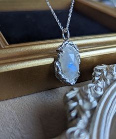 Moonstone wrapped in the elegant frame. Beautiful rose cut moonstone has beautiful blue flash inside, and to enjoy the natural beauty fully, you can wear it in two way; the front is mild milky white with soft blue flash. You can flip the moonstone with even stronger blue flash. One of a kind. Chain length: 45cm エレガントなフレームに包まれたムーンストーンに美しいブルーフラッシュが魅力のネックレス。ミルキーなホワイトと優しくブルーが輝くローズカットが美しいフロントだけでなく、より強いフラッシュが楽しめる裏側も抜かりなくフレームが細部まで装飾が施されているので２ウェイで楽しめるネックレスです。世界で一つだけのペンダントになります。 チェーンの長さは45cmです。 Rainbow Moonstone Necklace, Elegant Frame, Moonstone Necklace, Moonstone Jewelry, Milky White, Beautiful Rose, You Can, The Natural, Beautiful Roses