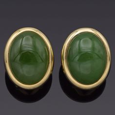 Weight: 9.8 Grams Stone: 17.10 TCW (16x12 mm) Green Jade Measurements: 19.8x15.9 mm Hallmark: 14K Gump's Item #: BR-906-030823-11 Luxury Green Oval Earrings, Luxury Yellow Gold Oval Clip-on Earrings, Luxury Oval Yellow Gold Clip-on Earrings, Luxury Oval Cabochon Earrings For Anniversary, Oval Yellow Gold Cabochons For Formal Events, Classic Oval Clip-on Earrings With Polished Finish, Elegant Green Cabochons For Formal Occasion, Luxury Oval Clip-on Earrings For Anniversary, Classic Yellow Gold Cabochons For Formal Occasions