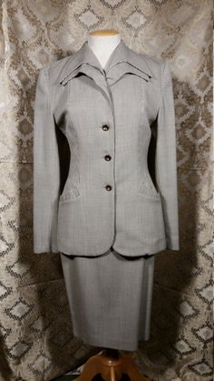 "Norma Kamali Power Suit from the 80s with wonderful retro 40s touches like the clever pocket flaps, double collar, and slightly flared peplum back.  Very film noir, the suit is 100% wool with a fully lined jacket and skirt.  The suit is in excellent condition. The label says size 10, and the measurements are approx: Jacket     18\" across the shoulders    40\" bust    32\" waist    40\" hips    25 1/2\" sleeve length    28\" overall length Skirt    30\" waist    40\" hips    24 1/2\" length See my entire shop collection here   https://www.etsy.com/shop/RobinClaytonVintage" Fitted Career Suits With Suit Collar, Fitted Suits With Suit Collar, Fitted Skirt Suit For Career In Fall, Classic Fitted Skirt Suit For Office, Fitted Semi-formal Pantsuit With Button Closure, Fitted Skirt Suit With Button Closure For Work, Timeless Fitted Suit For Fall, Fitted Pantsuit With Pockets And Suit Collar, Timeless Fitted Suits For Fall