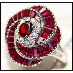 Our jewelry is entirely handmade in our Thailand studio. We focus on bringing creative and symbolic design to fine jewelry crafted in precious metal and set with superior quality gemstones and diamonds. For more Ruby Rings, click here: https://www.etsy.com/shop/BKGjewels?section_id=18901601 Ring information Metal: White Gold 18 Karat Gold Weight: 8.00 grams Size: 7 (US)  N (UK) Appraisal Value: $5899 Ruby information: Shape or Cut: Oval and Square Quantity: 1 and 44 Stones Total Weight: 0.45 and 4.36 carats (100% Genuine Natural) Clarity: Eye very clean Color: Red Diamond information: Shape or Cut: Round Brilliant Quantity: 12 Stones Total Weight: 0.23 carats (100% Genuine Natural) Clarity: Eye clean SI1-2 Color: G-H Colorless FEATURES - This item can be made with a variety of gemstones or Diamond Cocktail Ring, Sapphire Solitaire, Ruby Pendant, Diamond Cocktail Rings, Ruby Jewelry, Earrings Unique, Sapphire Earrings, I Love Jewelry, Ruby Diamond