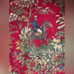 a man riding on the back of a brown horse next to a forest filled with trees