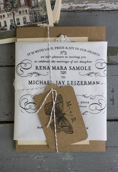 an old fashioned wedding card is tied to a piece of paper with twine on it