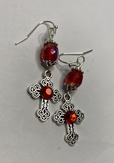 Simple, bright and lightweight! The crosses are adorned with red crystals making them so festive for the holidays!  Wear in good health! Nickel-free Red Crystal Earrings, Red Nickel-free Crystal Earrings, Handmade Red Cross Pendant Jewelry, Handmade Red Cross Jewelry, Handmade Red Crucifix Jewelry, Silver Cross Earrings, Red And Silver, Cross Earrings, Red Crystals