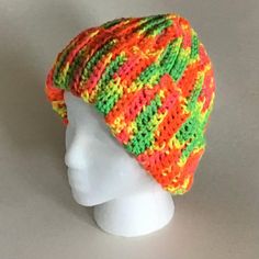 Here is a crocheted colorful hat made with bright striped acrylic yarn in shades of yellow, orange, red, pink and green. It can be worn cuffed or uncuffed. Measures 11" wide by 11" high when uncuffed. Machine wash warm; tumble dry; do not bleach; do not iron; dry cleanable. Multicolor Crochet Cap Hat, Multicolor Crochet Cap One Size, Multicolor Beanie For Beach, One Size, Multicolor Beanie One Size For Beach, Multicolor Beanie For Beach, One Size Fits Most, Multicolor Beanie Cap For Beach, Multicolor Beach Beanie Cap, Multicolor Cap Beanie For The Beach, Multicolor Crochet Cap In One Size