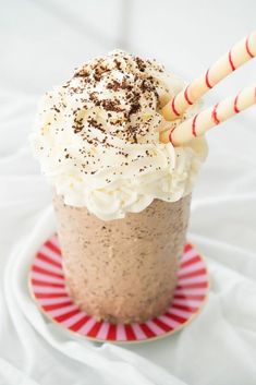 a chocolate drink with whipped cream and candy canes