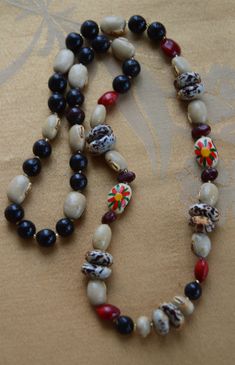 "Colorful nut and wooden beaded necklace is in mainly shades of red, brown and black. The necklace measures approx. 30\" in length and does not have a clasp. It is in very good vintage conditon. The necklace has stretched a bit leaving a small gap at the back of the necklace." Traditional Brown Beaded Necklaces With Black Beads, Traditional Brown Beaded Necklace With Black Beads, Shades Of Red, Red Brown, Boho Jewelry, Favorite Jewelry, Black And Brown, Gap, Beaded Necklace