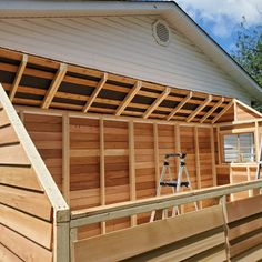 a house with wooden sidings on the roof and side walls that are being built