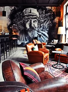 a living room filled with furniture and a mural on the wall