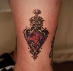 a woman's leg with a tattoo on it that has a heart in the center