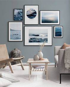 a living room filled with furniture and pictures hanging on the wall above it's coffee table