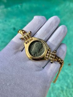 "Antique original Roman Coin Pendant with diamond side stones and set in a Cuban style 18k gold chain. Roman Coins date back to the 4th Century BCE around the year 326. This Bronze Roman Coin is estimated to originate in 325AD, with a detailed depiction of Constantius Gallus, the tyrannical nephew of Constantine I. A stunning vintage piece of heirloom quality. The protruding bezel setting also provides an additional layer of support to the antique coin. ✔ Metal: Yellow Gold ✔ Metal Purity: 18K ✔ Elegant Collectible Jewelry With Single Cut Diamonds, Collectible Diamond Necklace Fine Jewelry, Luxury Diamond Necklace For Collectors, Luxury 14k Stamped Cubic Zirconia Jewelry, Elegant Collectible Jewelry With Diamond Accents, Luxury White Gold Coin Necklace, Luxury Gold-plated Jewelry With Diamond Accents, Luxury Diamond Jewelry In Yellow Gold, Luxury Yellow Gold Jewelry With Cubic Zirconia