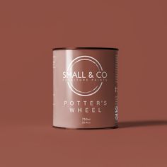 small and co potter's wheel coffee can on a pink background with the words,