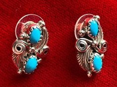 These earrings are beautiful bright blue Sleeping Beauty stud earrings. These earrings are set in sterling silver with twisted silver swirls, leaves, silver drops and two turquoise gems. Inspired by nature and are just lovely. Measures 3/4 inch in length and 1/2 inch in width.  Stamped Sterling and artist's hallmark on the back. Turquoise Clip-on Jewelry Gift, Turquoise Clip-on Jewelry For Gift, Inspired By Nature, Bright Blue, Jewelry Earrings Studs, Hallmark, Sleeping Beauty, Nature Inspiration, Silver Earrings