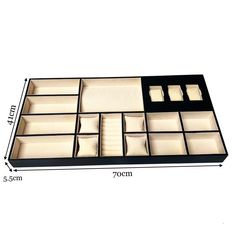 an open drawer is shown with compartments for various items and measurements to fit in it