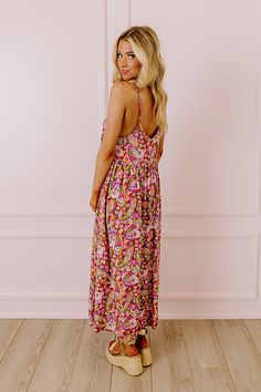 - Add a fresh take to your transitional wardrobe with this beautiful midi dress! - Unlined lightweight material patterned with a colorful floral print - A v-cut neckline and upper back with adjustable spaghetti straps - A relaxed silhouette that falls into a straight mid-calf length hemline