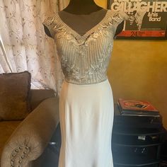 Gorgeous Ivory Fit & Flare Gown. Bodice Filled With Sparkle From Rhinestones, Beads And Silver Embroidery. Outer Layer 100%Silk Crepe. A Couple Small Holes In Illusion. Tulle And Rhinestones Don’t Mix Well As The Tulle Always Gets Caught On Them, But Easily Covered By Adding Small Amount Of Beadwork, Which I Can Do If Desired. Price Is Way Below What I Paid Wholesale From The Designer. White Embellished V-neck Evening Dress, Beaded V-neck Evening Dress For Wedding, Elegant Evening Wedding Dress With Rhinestones, White Embellished V-neck Gown, White Embellished Mother Of The Bride Evening Dress, White Embellished Mother Of The Bride Dress For Evening, White Embellished Evening Dress For Formal Occasions, Elegant Silver Embellished Wedding Dress, White Embellished Mother Of The Bride Dress For Party