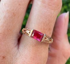 Gorgeous vintage gold plated ring featuring a red crystal stone and ornate detailing on the band. Band is marked '18K GP'. Size 7.75 Ruby Ring Gold, Black Stone Ring, Raw Stone Ring, Dainty Gold Rings, Gold Solitaire Ring, Pink Sapphire Ring, Woodland Hills, Emerald Engagement Ring Cut, Ruby Engagement Ring