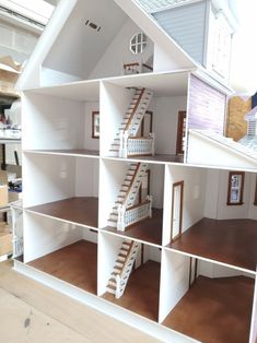 a doll house with stairs and windows on the top floor is made out of cardboard