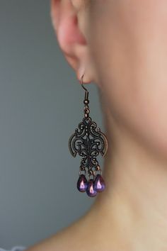 Beautiful and unique boho earrings with purple czech glass 6x9 mm drop beads,  antique copper chandelier charms and antique copper earring hooks. Earring hooks are from nickel free and lead free metal. Unique jewelry for your boho outfit or a great gift for someone special! *The total lenght of earrings is about 65 mm including earring hooks. Other earrings of my shop you can see here: https://www.etsy.com/shop/NaTavelli?section_id=13757927  Thanks for visit. Purple Teardrop Chandelier Earrings As Gift, Purple Teardrop Metal Jewelry, Purple Drop Chandelier Earrings As Gift, Ornate Purple Jewelry With Matching Earrings, Nickel-free Purple Earrings For Festival, Nickel Free Purple Earrings For Festival, Purple Metal Drop Earrings, Ornate Purple Dangle Earrings, Purple Dangle Metal Jewelry