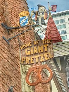 a sign on the side of a building that says home of the giant pretzel