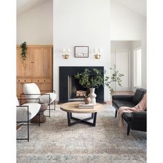 a living room filled with furniture and a fire place