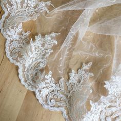 an image of white lace on wood floor