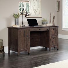 a wooden desk with a laptop on top of it