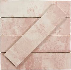 a piece of pink marble sitting on top of a wooden floor