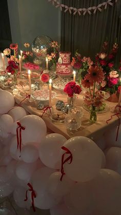 a table with balloons, candles and flowers on it for a wedding or birthday party