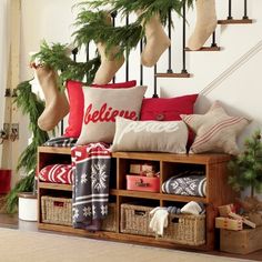 a christmas scene with stockings and pillows on the bannister shelf next to stairs