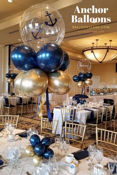 an anchor balloon centerpiece with blue, gold and silver balloons is displayed in the middle of a banquet room