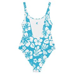 Live your best beach life in our White Hawaiian Flowers on Aqua Blue One-Piece Swimsuit. With a beautiful floral print and flattering fit, this swimsuit is perfect for all shapes and sizes. The silky smooth material will have you feeling the Aloha love while you chill at the beach or pool. Now that's something to be Extremely Stoked about!• 82% Polyester, 18% Spandex• Chlorine-resistant fabric• Cheeky fit with a scoop neckline and a low scoop back• Zig-zag stitching• Double-layer front• Four-way Tropical One-piece Swimwear For Beach Season, Casual One-piece Swimwear For Pool, Tropical One-piece Swimwear For Sunbathing, Tropical One-piece For Sunbathing, Summer Tropical Print Swimwear For Pool, Fitted Hawaiian Swimwear For Summer, Floral Print Surfing Swimwear Beachwear, Fitted Tropical Print Swimwear For Beach, Blue Surfing Bodysuit For Beach Season