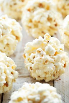 popcorn balls are sitting on a wooden table