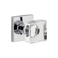 a chrome and clear glass door handle on a white wall mounted shower faucet