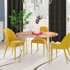 a dining room table with yellow chairs and a chandelier hanging from the ceiling