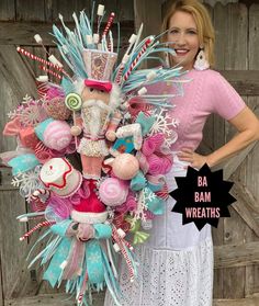 a woman standing next to a bouquet made out of candy canes and candies