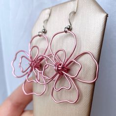 Pink magnolia flower statement earrings. Handworked, pink wire has been wrangled into an abstract, rustic magnolia or dogwood flower motif. These drop earrings are ultra modern and bring an effortless charm into any wardrobe.  One of a kind. Each pair is made to order and slight variations may occur. Earrings are approximately 2" in length, very lightweight, and on surgical steel French earwires. Other colors now available! Makes a beautiful gift for mom, sister, or any trendy, floral loving fri Pink Magnolia Flower, Flower Statement Earrings, Dogwood Flower, Pink Dogwood, Pink Magnolia, Daisy Jewelry, Dogwood Flowers, Flower Motif, Magnolia Flower