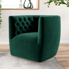 a green chair sitting on top of a wooden floor next to a plant in a vase