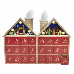 a wooden toy house with christmas decorations on the roof and numbers painted on the side