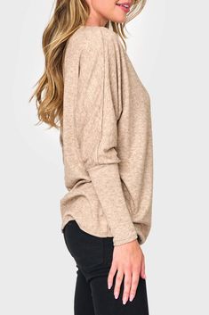 This sweater knit top is the epitome of relaxed style. With its eased fit and slouchy/off-shoulder design, it exudes effortless charm. The long sleeves feature high cuffs, adding a touch of sophistication. Made from super soft fabric, it offers both comfort and a luxurious feel. 50% Rayon | 28% Polyester | 22% Nylon Hand Wash Cold, Dry Flat Length 25 1/2" (size small) Drape Wide Neck Long Dolman Sleeve Eased Fit Easy 30-Day Returns & Exchanges Sabrina is 5'7 and wearing XS in Black & Martini Oli Casual Boat Neck Winter Sweater, Casual Boat Neck Sweater For Winter, Casual Winter Sweater With Boat Neck, Casual Oversized Boat Neck Top, Chic Oversized Soft Knit Top, Oversized Soft Knit Chic Top, Knit Tops With Ribbed Cuffs And Balloon Sleeves, Versatile Off-shoulder Top For Fall, Casual Long Sleeve Balloon Top For Fall