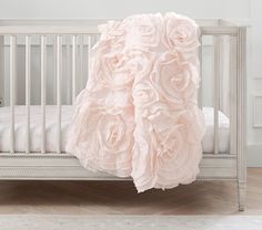 a white crib with pink roses on it