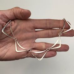 "This necklace is made of individual hammered links.  Each link has both a hammered curve and a hammered point.  The necklace alternates longer points and shorter points.  If you choose the three link or the five link option, the rest of necklace will be rolo chain.  Please let me know the total chain length you would like.  The eleven link necklace is 16\" long.  The twelve link necklace is a little over 17\" long.  The 13 link chain is 18.5\" long.   The necklace will be shipped in a decorativ Hammered Wire Jewelry, Metalsmithing Jewelry, Modernist Jewelry, Basic Jewelry, Dope Jewelry, Rochester Ny, Silver Plated Jewelry, Pretty Earrings, Rolo Chain