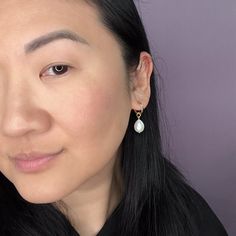 These dainty glass pearl drops are sublime! A must for your accessory closet, they can be worn every day or with glam formal wear and the like. The charms hang from elegant 14k gold-filled hoops and are removable so you can wear the hoops on their own—two earrings in one! Try them with the 15mm hoops for a classic, every day look, or go for a more statement-making look with large 34mm hoops. They're so versatile and perfect for travel! Looking for other hoop sizes? Shop them here. Charm measures Minimalist Teardrop Hoop Earrings With Pearl Charm, Minimalist Teardrop Pearl Earrings With Charm, Minimalist Teardrop Pearl Charm Earrings, Pearl Teardrop Hoop Earrings With Pearl Drop, Hypoallergenic Pearl Teardrop Hoop Earrings, Hypoallergenic Teardrop Pearl Hoop Earrings, Pear Shaped Pearl Chain Earrings, Everyday Minimalist Pearl Drop Teardrop Earrings, Teardrop Pearl Earrings For Pierced Ears